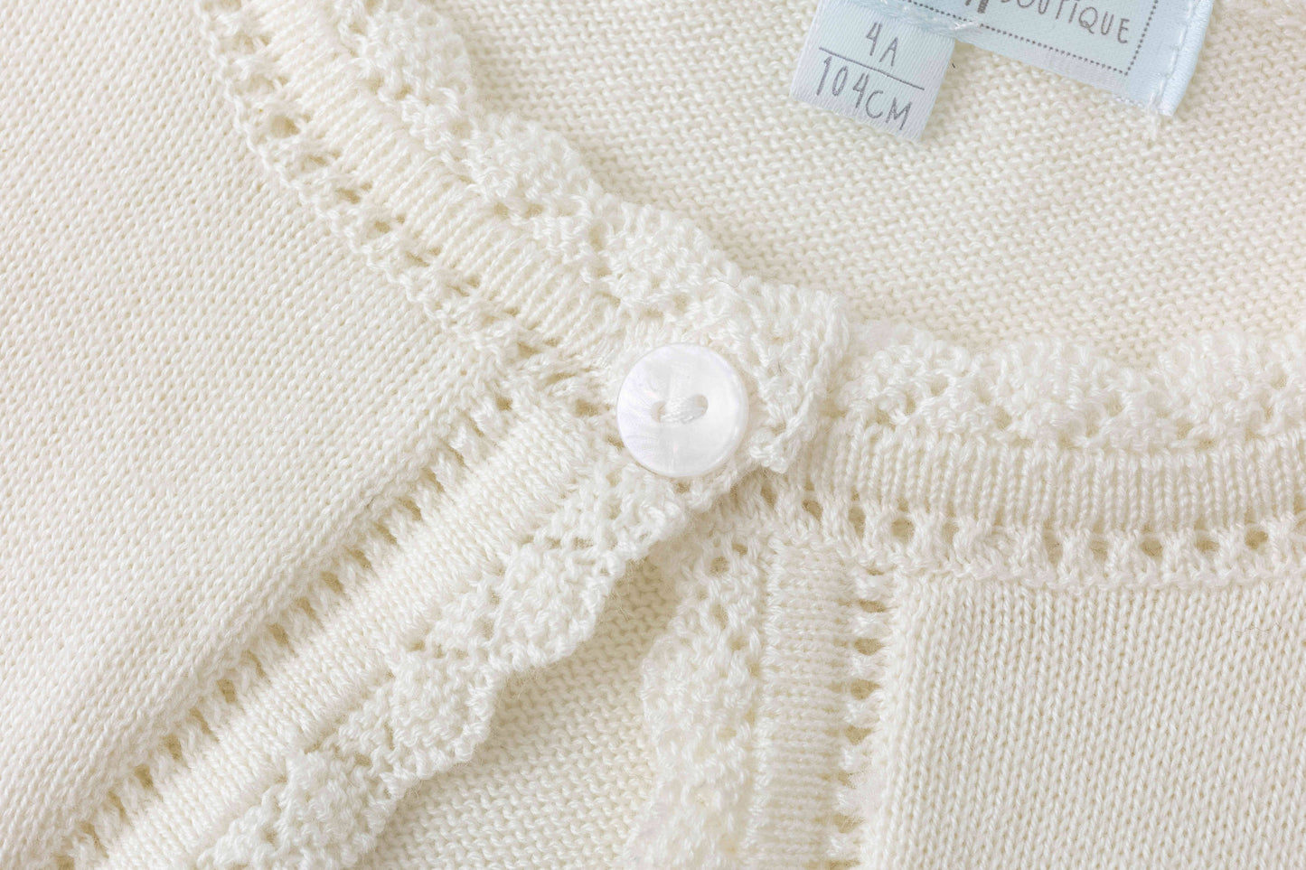 Crèmekleurig vest voor meisje met strikje