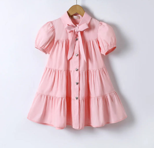 Roze katoenen jurk met pofmouw en strik